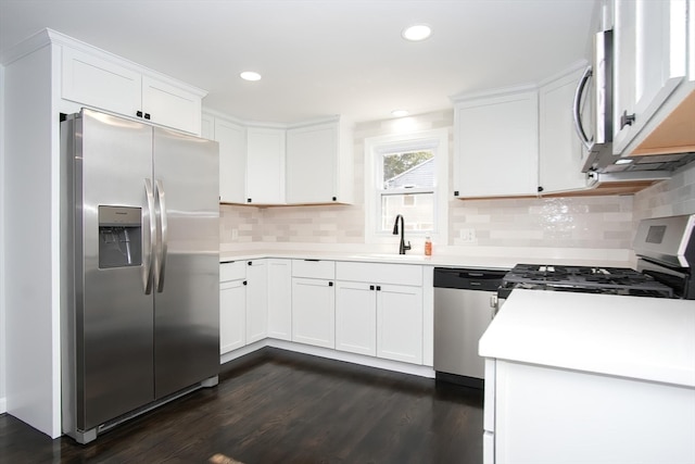 kitchen with white cabinetry, stainless steel appliances, sink, and dark hardwood / wood-style floors