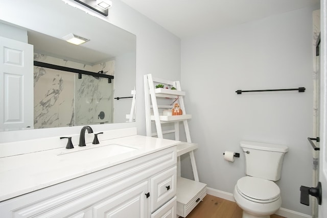 bathroom featuring vanity, toilet, walk in shower, and wood-type flooring