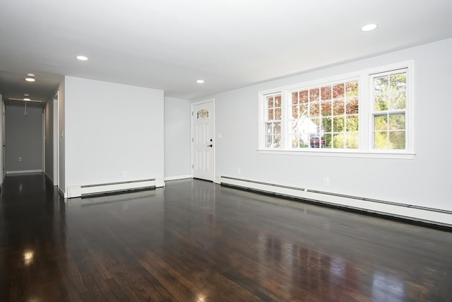 spare room with a baseboard radiator and wood-type flooring