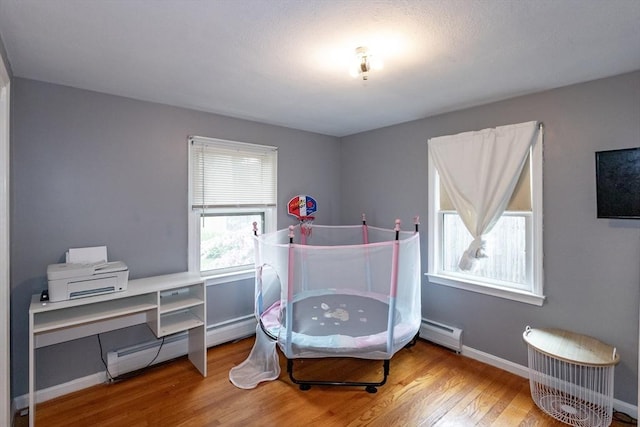67 Donbray Rd, Springfield, MA 01119 - bedroom featuring a baseboard heating unit, wood finished floors, and baseboards