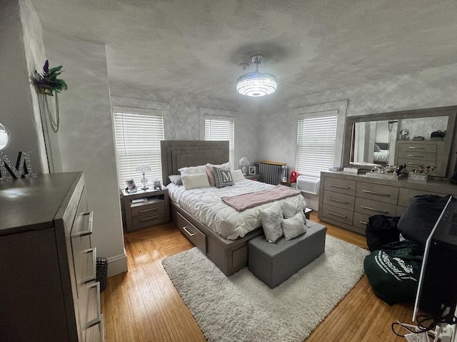 59-61 Waite St, Malden, MA 02148 - bedroom with light wood-style floors and a textured ceiling