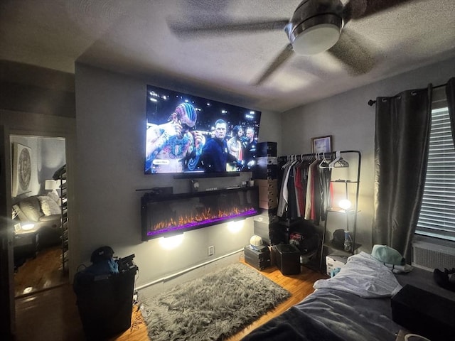 59-61 Waite St, Malden, MA 02148 - home theater with wood finished floors, a ceiling fan, and a textured ceiling
