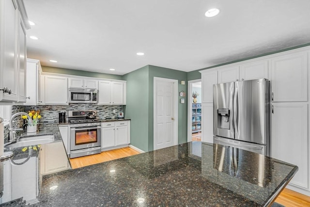 4 Kattail Rd, Hudson, MA 01749 - kitchen featuring stainless steel appliances, backsplash, white cabinets, dark stone countertops, and recessed lighting