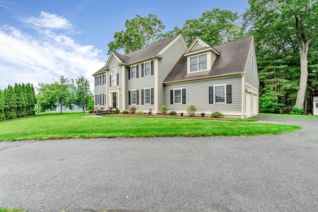 4 Kattail Rd, Hudson, MA 01749 - colonial house featuring asphalt driveway, a front yard, and a shingled roof
