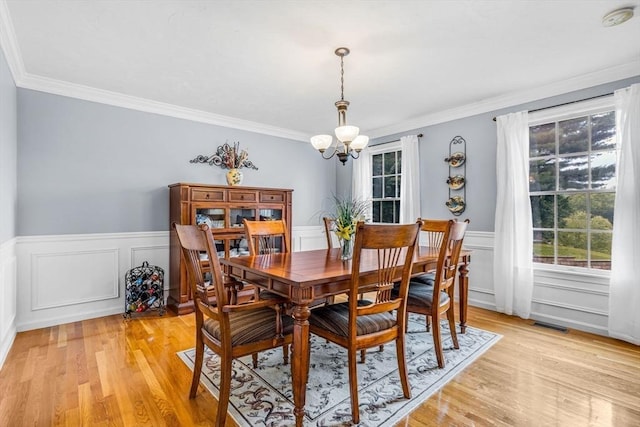 4 Kattail Rd, Hudson, MA 01749 - dining space featuring a chandelier, healthy amount of natural light, ornamental molding, light wood-type flooring, and wainscoting