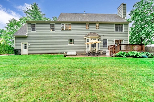 4 Kattail Rd, Hudson, MA 01749 - rear view of property featuring a chimney, a wooden deck, a yard, and roof with shingles