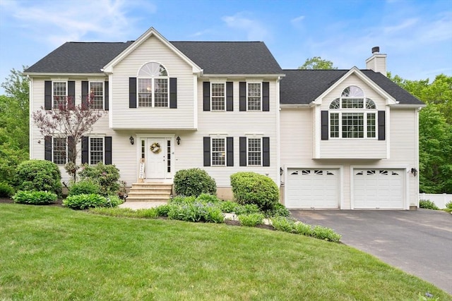 16 Preserve Way, Sturbridge, MA 01566 - view of front facade featuring a chimney, a garage, asphalt driveway, a front lawn, and a shingled roof