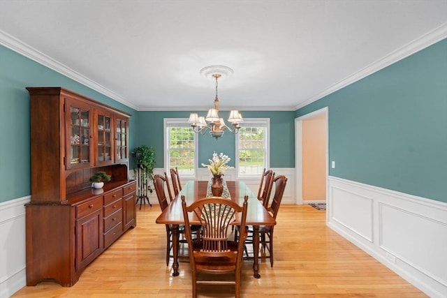 16 Preserve Way, Sturbridge, MA 01566 - dining space with a chandelier, wainscoting, ornamental molding, light wood-style floors, and a decorative wall