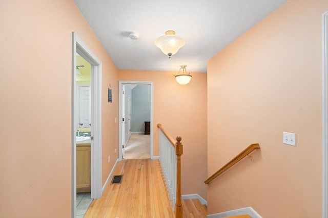 16 Preserve Way, Sturbridge, MA 01566 - hallway with an upstairs landing, light wood-type flooring, a sink, and baseboards