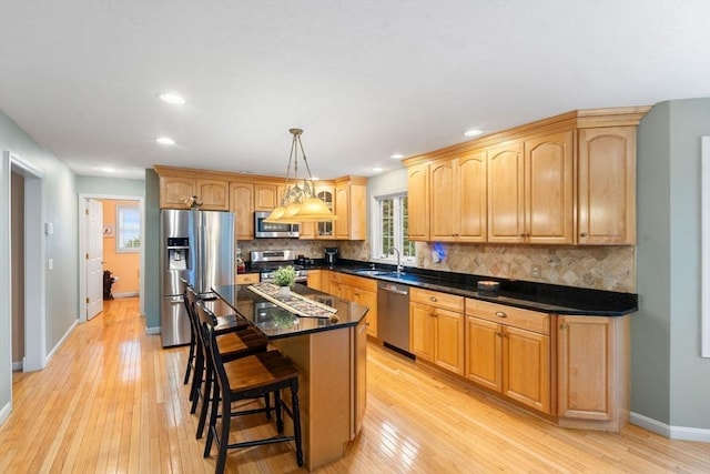 16 Preserve Way, Sturbridge, MA 01566 - kitchen featuring stainless steel appliances, baseboards, backsplash, light wood finished floors, and a sink