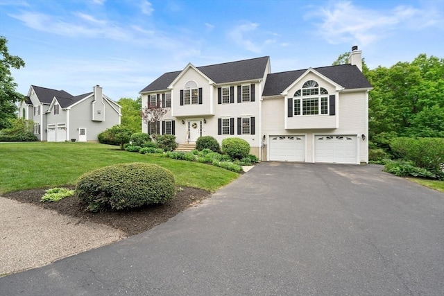 16 Preserve Way, Sturbridge, MA 01566 - colonial home featuring a garage, a front yard, driveway, and a chimney
