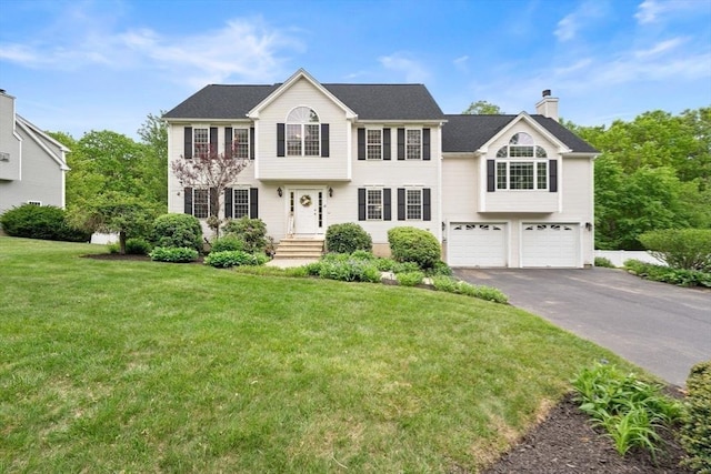 16 Preserve Way, Sturbridge, MA 01566 - view of front facade with asphalt driveway, an attached garage, a chimney, and a front lawn