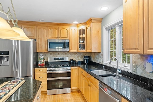 16 Preserve Way, Sturbridge, MA 01566 - kitchen with appliances with stainless steel finishes, a sink, glass insert cabinets, light wood-style floors, and backsplash