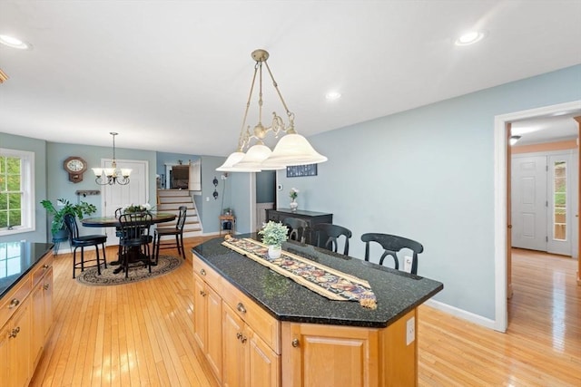 16 Preserve Way, Sturbridge, MA 01566 - kitchen featuring light wood finished floors, a center island, pendant lighting, dark stone counters, and recessed lighting