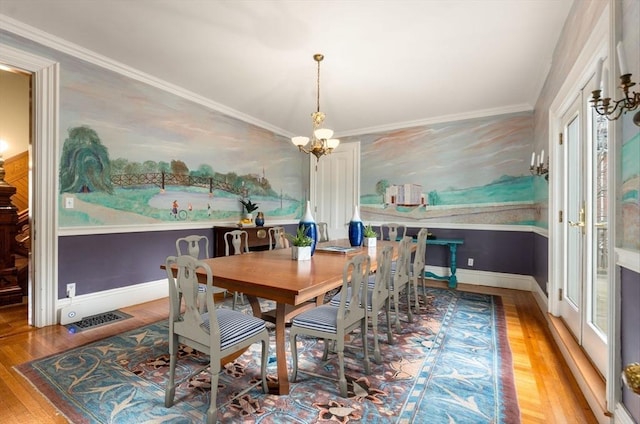dining space featuring ornamental molding, baseboards, visible vents, a notable chandelier, and wood finished floors