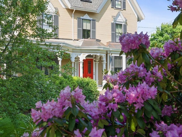 exterior space featuring roof with shingles