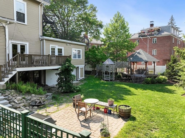 view of yard with a wooden deck, a gazebo, stairs, and a patio area