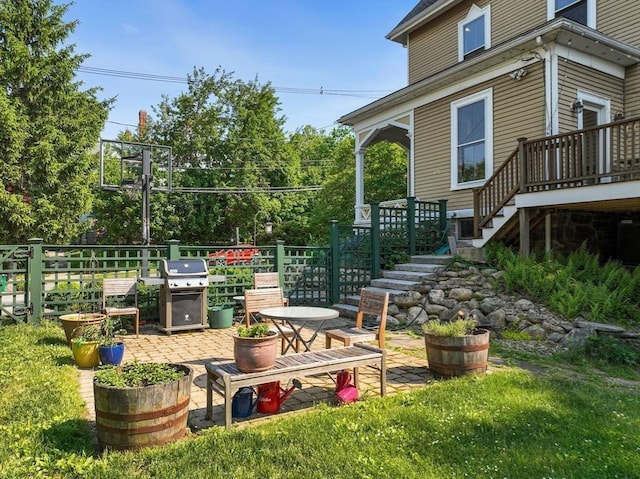 view of yard with a deck, stairs, and a patio
