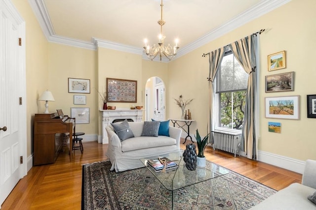 living area featuring arched walkways, an inviting chandelier, crown molding, and radiator
