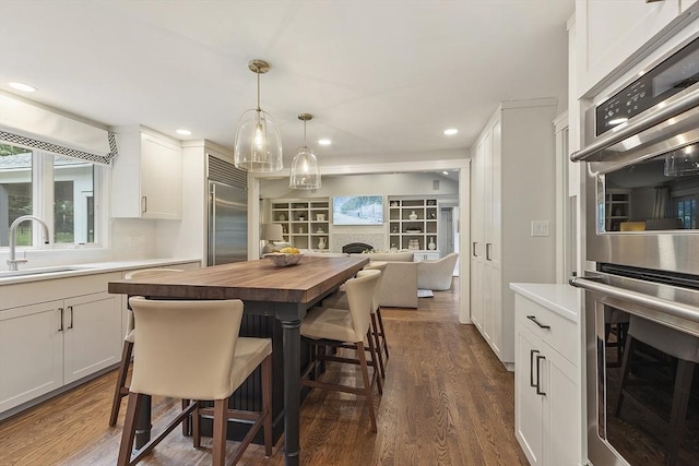 22 High St, Southborough, MA 01772 - dining area with dark wood finished floors, recessed lighting, and a fireplace