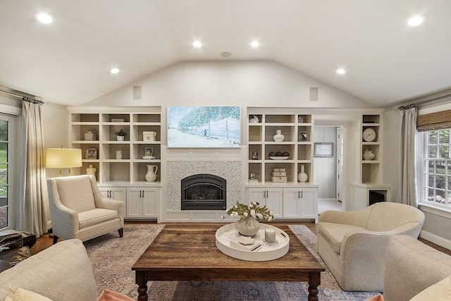 22 High St, Southborough, MA 01772 - living room with recessed lighting, lofted ceiling, a tile fireplace, built in shelves, and wood finished floors