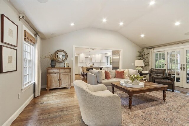 22 High St, Southborough, MA 01772 - living room with light wood-type flooring, lofted ceiling, french doors, and recessed lighting