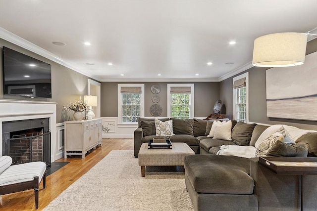 22 High St, Southborough, MA 01772 - living room featuring crown molding, light wood-type flooring, recessed lighting, and a fireplace with flush hearth