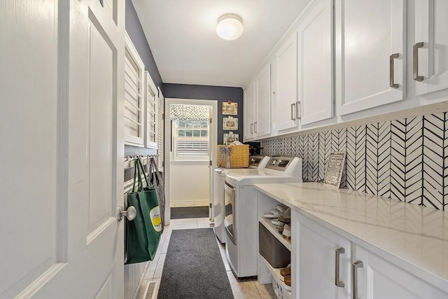 22 High St, Southborough, MA 01772 - laundry room with washer and dryer, cabinet space, and light tile patterned floors