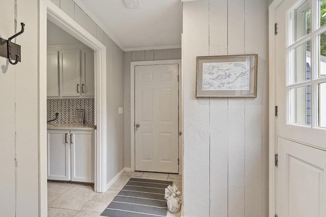 22 High St, Southborough, MA 01772 - entryway featuring light tile patterned flooring and crown molding