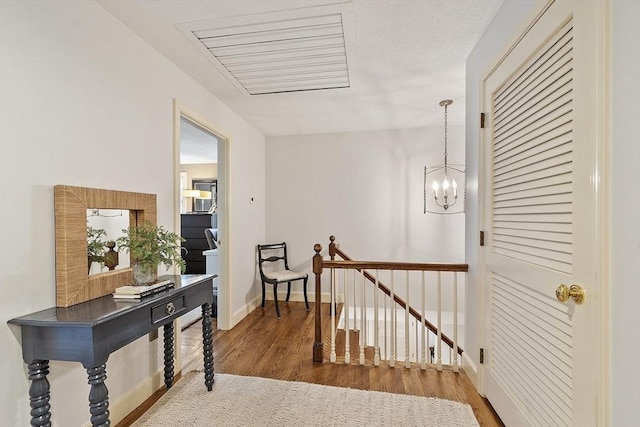 22 High St, Southborough, MA 01772 - hallway with an upstairs landing, wood finished floors, and a chandelier