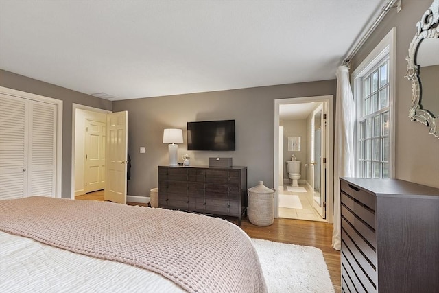 22 High St, Southborough, MA 01772 - bedroom with light wood-type flooring, ensuite bath, and a closet