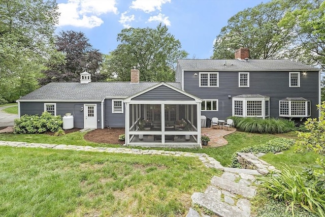 22 High St, Southborough, MA 01772 - back of property with a sunroom, a chimney, a patio, and a yard