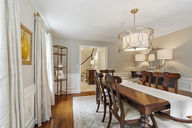 22 High St, Southborough, MA 01772 - dining space with stairs, wainscoting, wood-type flooring, and a decorative wall
