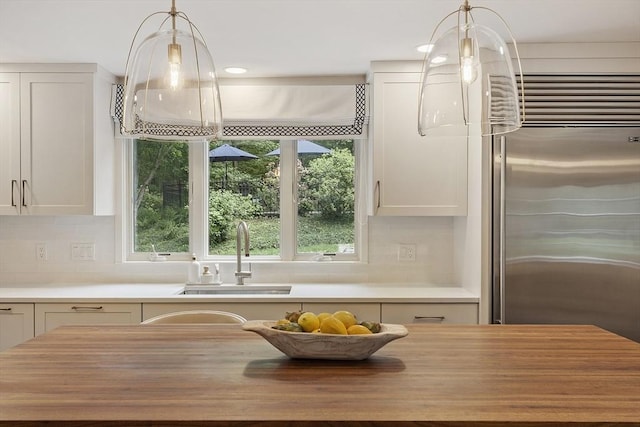 22 High St, Southborough, MA 01772 - kitchen featuring butcher block counters, built in fridge, healthy amount of natural light, backsplash, and recessed lighting