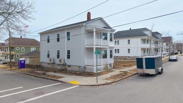 exterior space featuring a residential view and a chimney