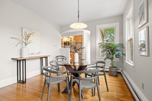 464 Windsor St Unit 3, Cambridge, MA 02141 - dining room with baseboard heating, light wood finished floors, and arched walkways