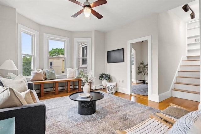 464 Windsor St Unit 3, Cambridge, MA 02141 - living area with wood finished floors, a ceiling fan, stairway, and a baseboard radiator