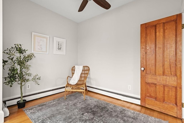 464 Windsor St Unit 3, Cambridge, MA 02141 - sitting room with wood finished floors, ceiling fan, and a baseboard heating unit