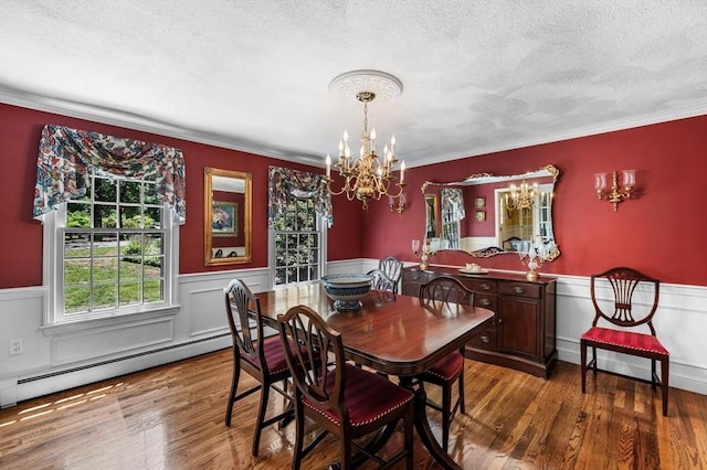 38 Lincoln Cir E, Andover, MA 01810 - dining room featuring a chandelier, a wainscoted wall, a textured ceiling, crown molding, and wood finished floors