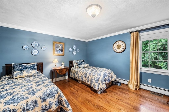 38 Lincoln Cir E, Andover, MA 01810 - bedroom with crown molding, a textured ceiling, wood finished floors, and a baseboard heating unit