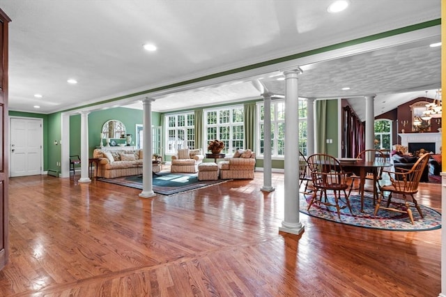 38 Lincoln Cir E, Andover, MA 01810 - living area with ornate columns, crown molding, plenty of natural light, wood finished floors, and recessed lighting