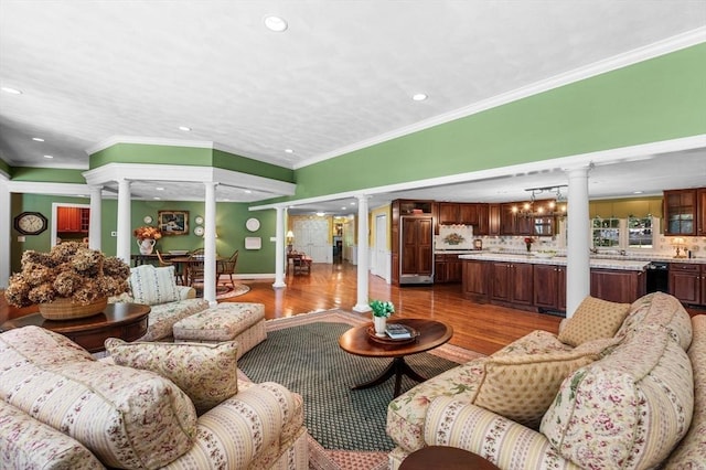 38 Lincoln Cir E, Andover, MA 01810 - living area featuring decorative columns, wood finished floors, recessed lighting, and ornamental molding