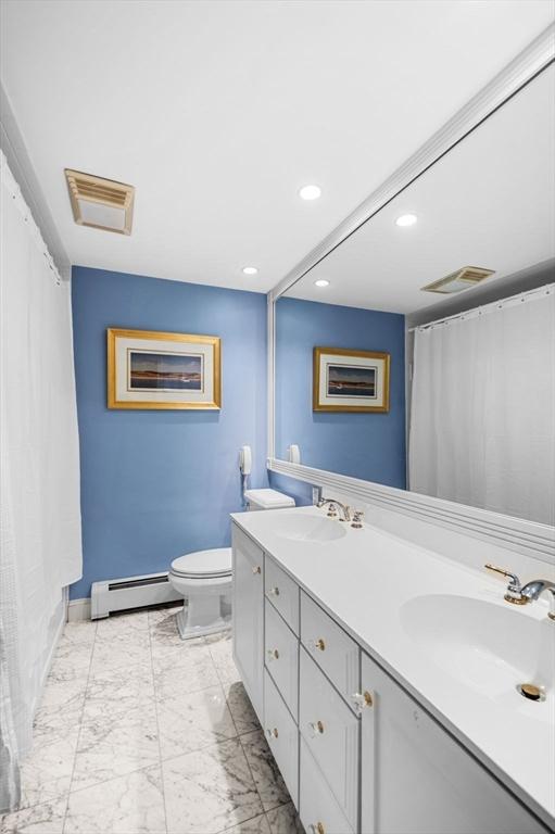 38 Lincoln Cir E, Andover, MA 01810 - full bath featuring a baseboard radiator, double vanity, recessed lighting, marble look tile flooring, and curtained shower