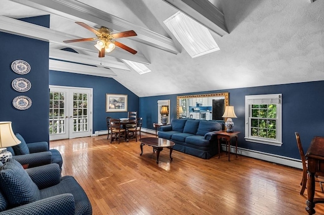 38 Lincoln Cir E, Andover, MA 01810 - living area with baseboard heating, a skylight, a ceiling fan, hardwood / wood-style flooring, and healthy amount of natural light