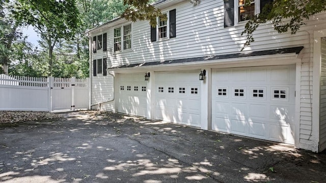 38 Lincoln Cir E, Andover, MA 01810 - view of side of property featuring an attached garage and asphalt driveway