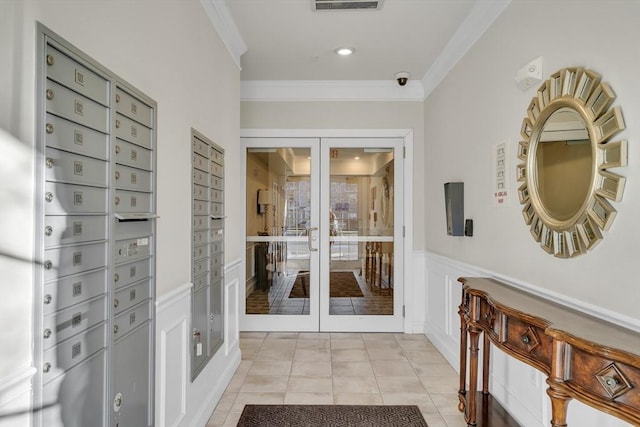 doorway to outside featuring crown molding, light tile patterned floors, and a mail area