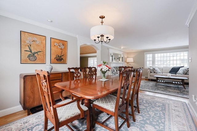 dining area with ornamental molding and wood-type flooring