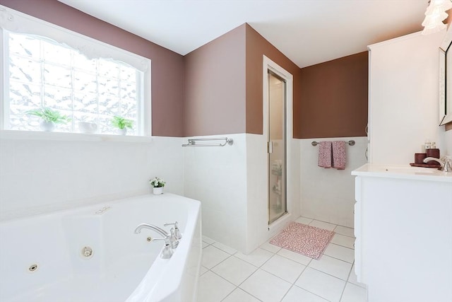 bathroom with tile patterned floors, independent shower and bath, and vanity