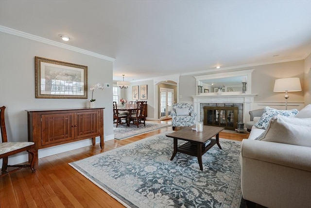 living room with crown molding and light wood-type flooring