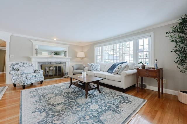 living room featuring crown molding and hardwood / wood-style flooring